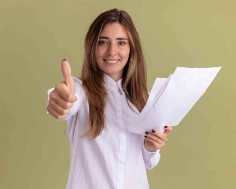 jpeg optimizer smiling young pretty caucasian girl holds blank paper sheets thumbs up isolated olive green wall with copy space 1