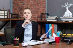 jpeg optimizer top view young lady sitting table holding document making silence gesture office